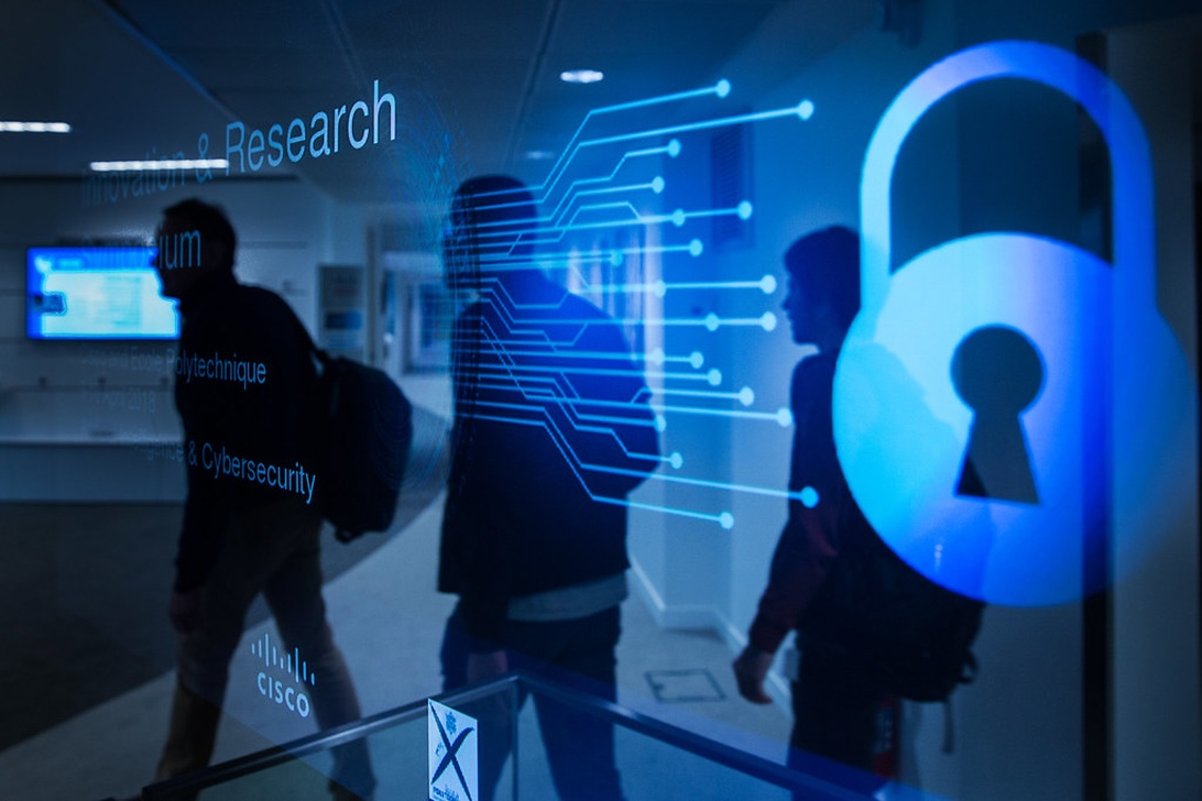 Symbolinen kuva tutkimuksen turvaamisesta, jossa näkyy lukon ikoni digitaalisen piirilevyn ja tutkimuslaitoksen siluettien päällä.